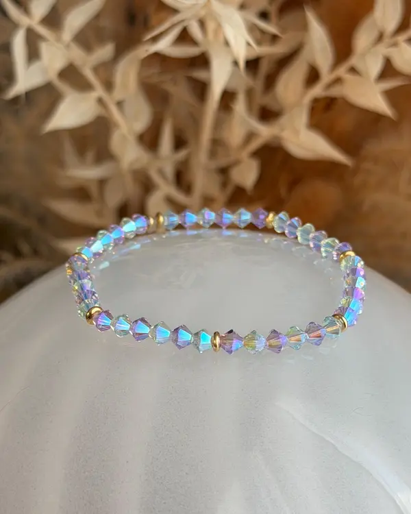Hand-strung bracelet of lilac and light blue crystal beads with gold-tone spacers